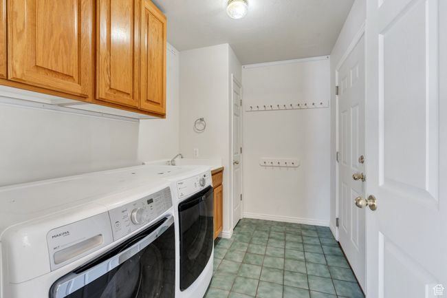 Washroom with cabinet space and washing machine and dryer | Image 15