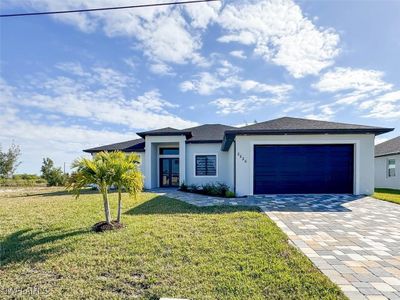 Prairie-style house featuring a garage and a front yard | Image 1