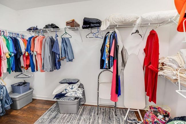 Walk in closet with wood finished floors | Image 24