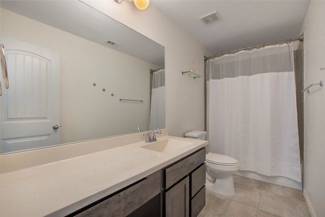 Bathroom featuring vanity, tile patterned floors, and curtained shower | Image 31