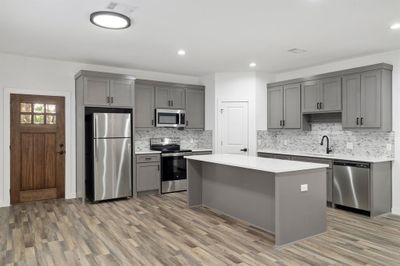 Kitchen with gray cabinets, appliances with stainless steel finishes, and hardwood / wood-style flooring | Image 3