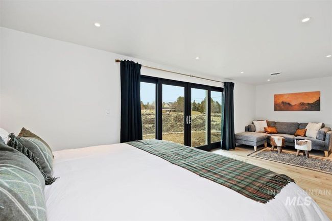 Bedroom featuring access to exterior, wood finished floors, recessed lighting, and french doors | Image 41