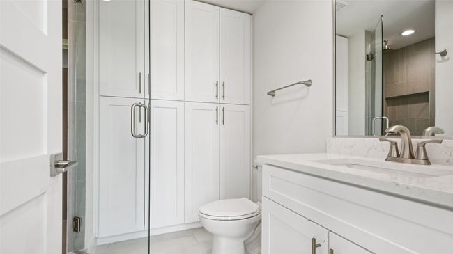 Bathroom with vanity, a shower stall, light tile patterned floors, a closet, and recessed lighting | Image 23