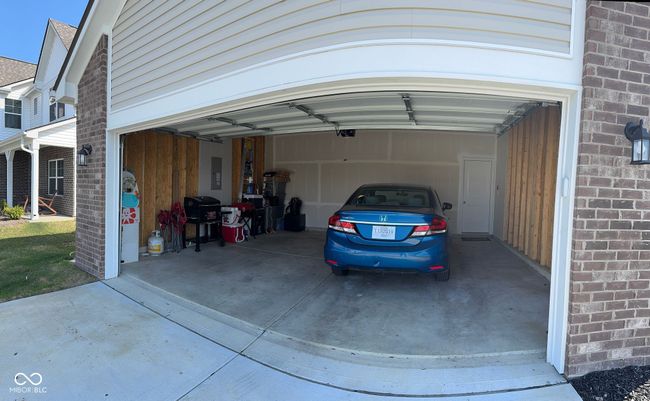 exterior space with driveway, electric panel, and a garage | Image 4
