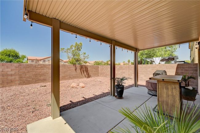 Fenced backyard with a patio | Image 28