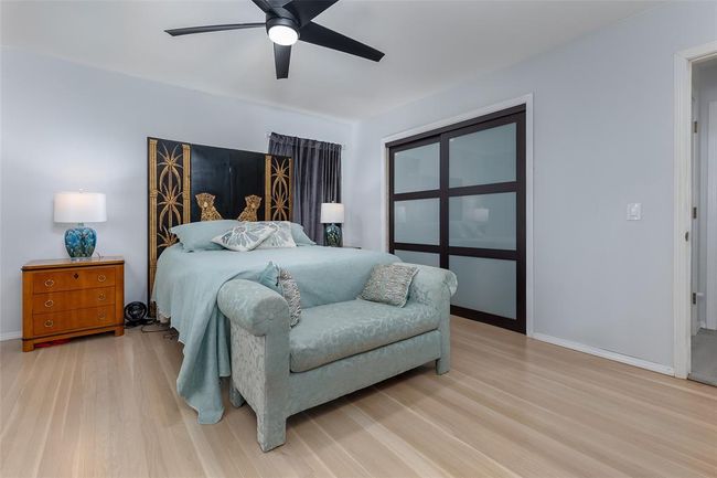 Bedroom with ceiling fan and light wood-type flooring | Image 27