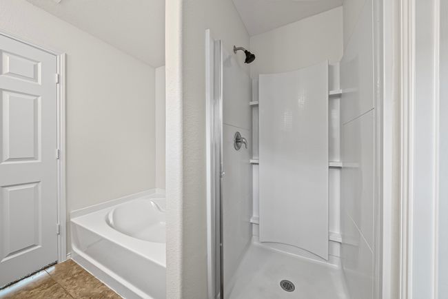 Full bathroom with a shower stall, a bath, and tile patterned floors | Image 23