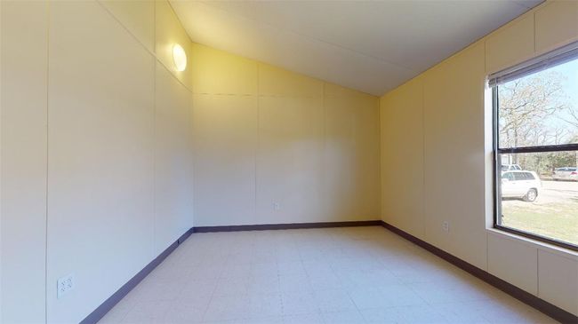 Empty room with light flooring and lofted ceiling | Image 50