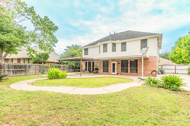 Back of house with a patio, brick siding, and a fenced backyard | Image 37