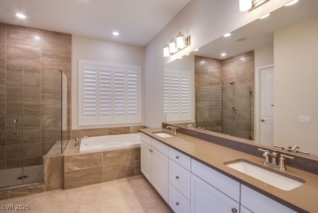Bathroom with tile patterned floors, a shower stall, and a sink | Image 10