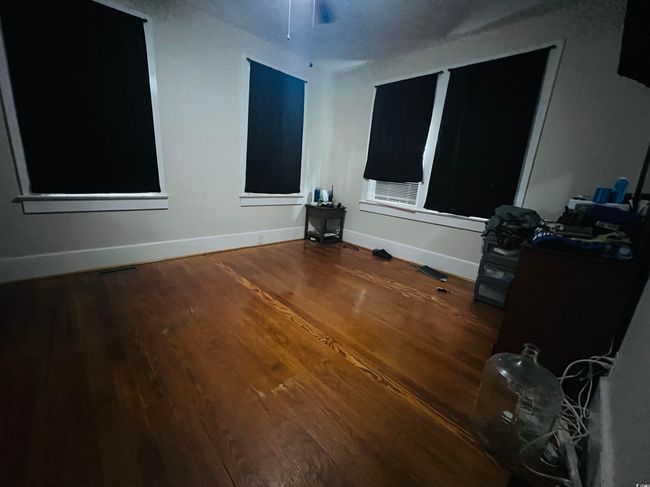 Empty room featuring baseboards and wood finished floors | Image 11