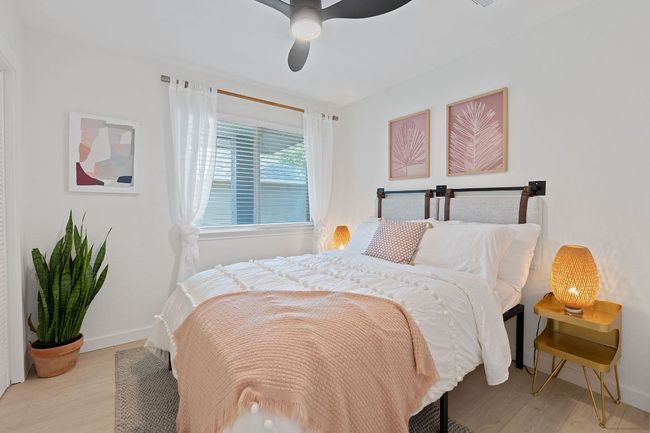 Bedroom featuring light wood-style floors and a ceiling fan | Image 15
