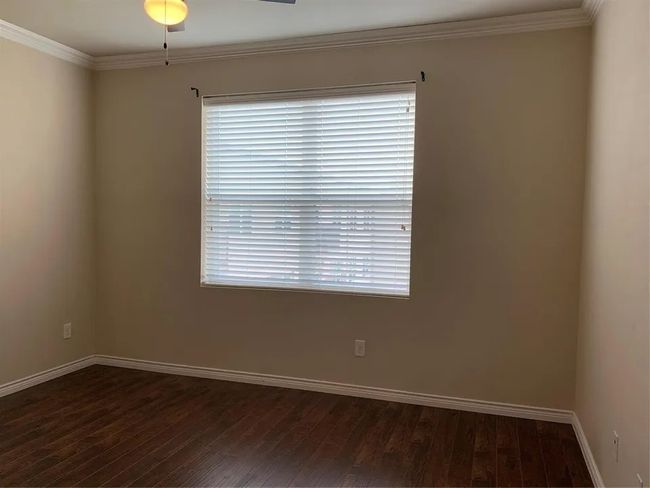 Unfurnished room with dark wood-type flooring and crown molding | Image 24