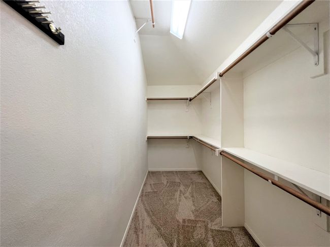 Spacious closet featuring light colored carpet and lofted ceiling | Image 10