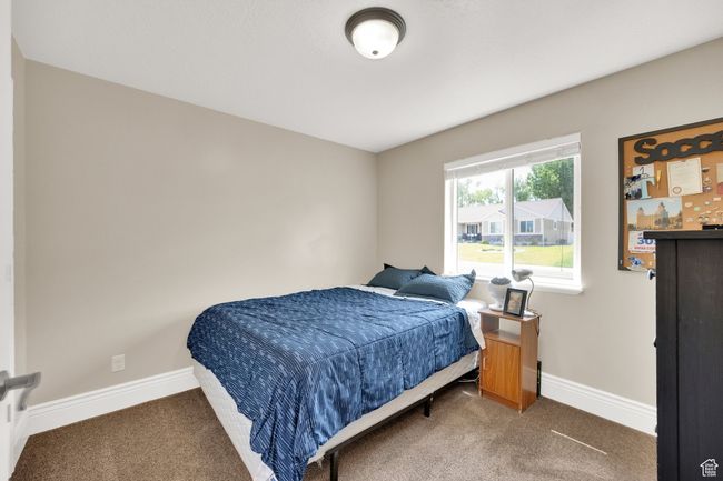 Bedroom with carpet floors and baseboards | Image 13
