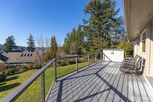 Gorgeous knotty pine vaulted ceilings in living and dining areas showing views and gas fireplace with custom straight grain fir mantel | Image 18
