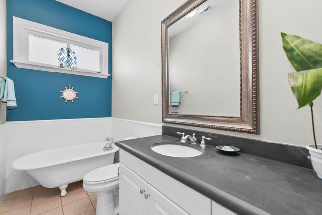 Discover the charm of the downstairs full bath, featuring a classic clawfoot tub. | Image 28