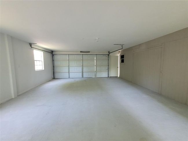 This oversized garage has plenty of room for large cars and storage | Image 30
