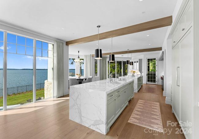 Stunning kitchen with two islands and integrated appliances with cabinet panels for a seamless aesthetic. | Image 9