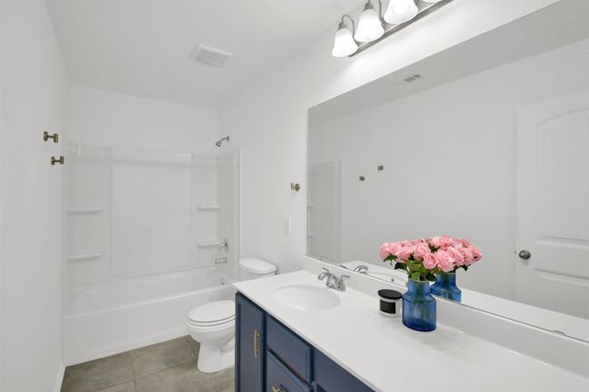 Bathroom with visible vents, vanity, toilet, and tile patterned floors | Image 29