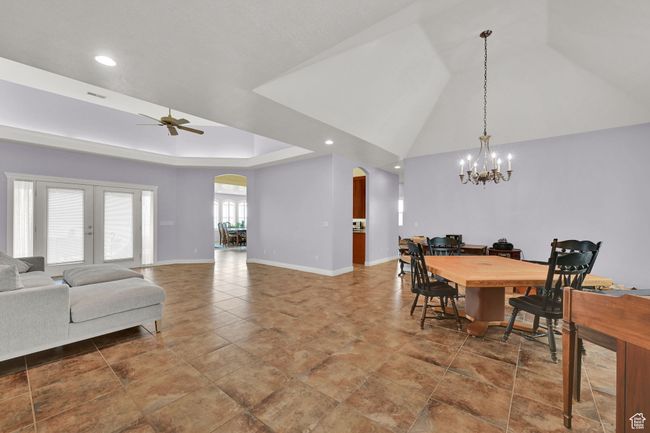 Dining space featuring arched walkways, baseboards, recessed lighting, and ceiling fan with notable chandelier | Image 11