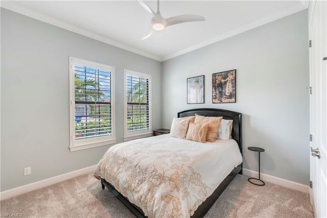 Carpeted bedroom featuring baseboards, ornamental molding, and ceiling fan | Image 27