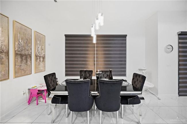 Dining area with marble look tile flooring and baseboards | Image 20