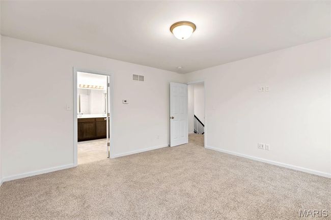 Unfurnished bedroom with light colored carpet and ensuite bathroom | Image 15
