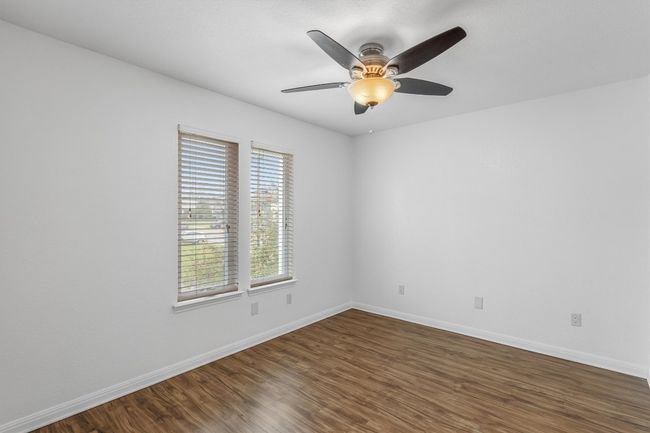 Unfurnished room with baseboards and dark wood-style flooring | Image 21