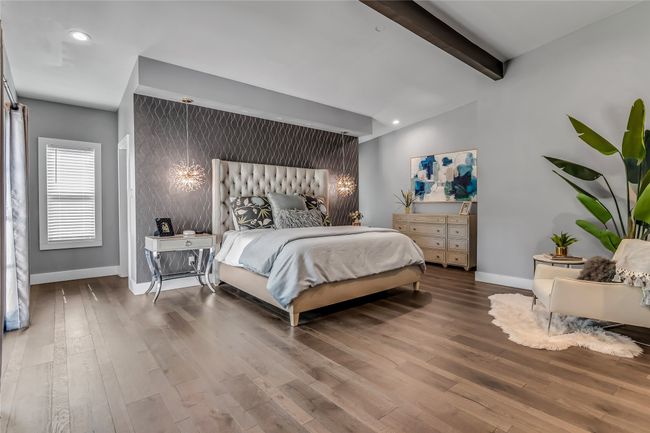 Bedroom featuring beamed ceiling, wood finished floors, recessed lighting, and ensuite bath | Image 18