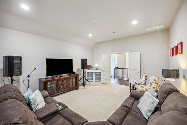 Carpeted living room with recessed lighting, vaulted ceiling, and visible vents | Image 20