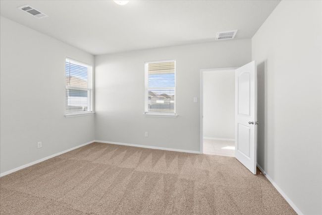 Spare room featuring carpet flooring, baseboards, and visible vents | Image 16