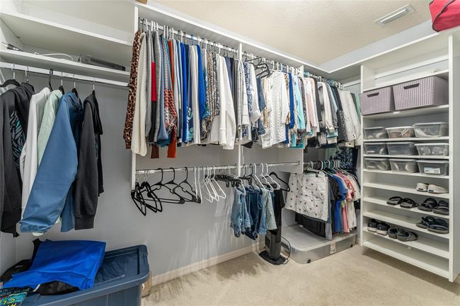 Primary Walkin closet with custom shelving. All bedroom closets have custom shelving. | Image 16