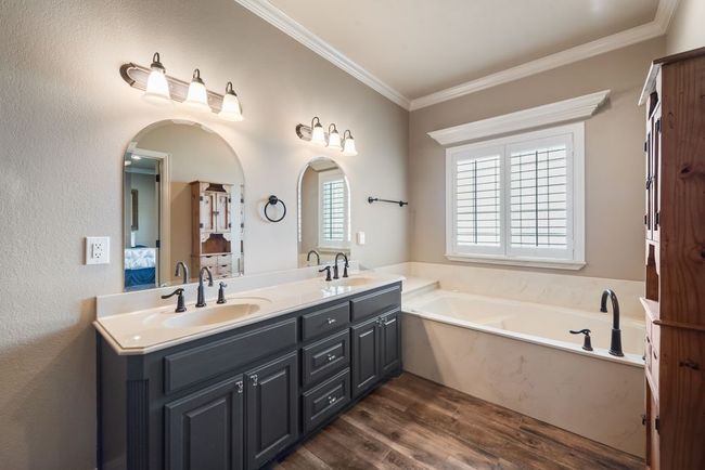 The primary bath features dual sink and a large soaking tub, perfect for a relaxing bubble bath! | Image 18