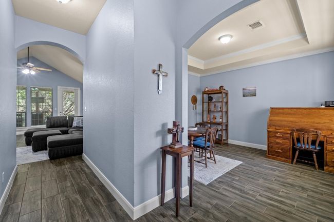 Hall with arched walkways, baseboards, dark wood finished floors | Image 20