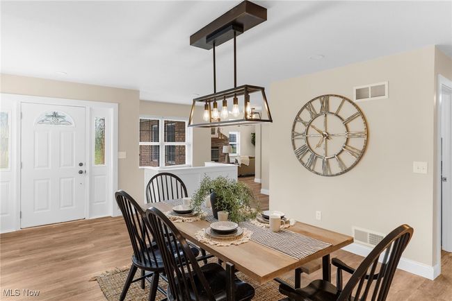 Dining area with light wood finished floors and baseboards | Image 9