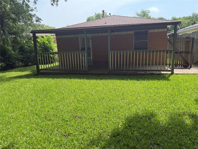 Back of house with brick siding and roof with shingles | Image 24