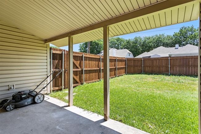 Fenced backyard with a patio and a gate | Image 21