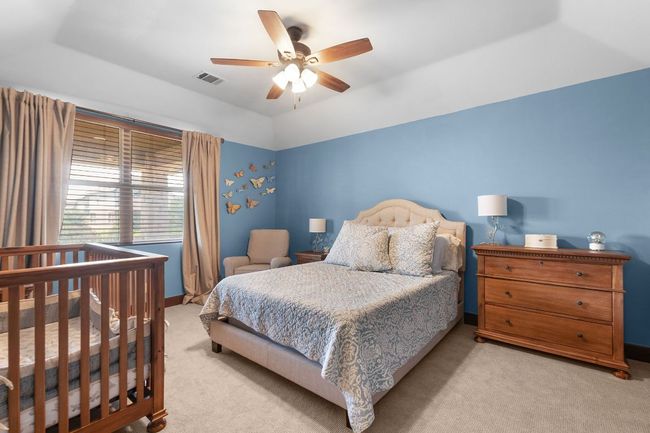 Carpeted bedroom upstairs with a ceiling fan | Image 24