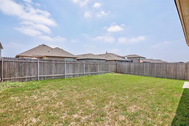 View of fenced backyard | Image 26