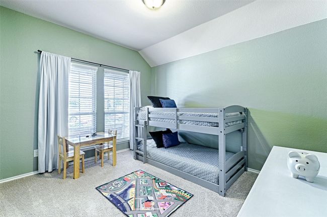 Carpeted bedroom with vaulted ceiling and baseboards | Image 17