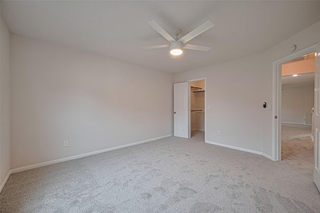 One of three secondary bedrooms upstairs, featuring closet space, all new carpet, freshly painted walls and ceiling, and a brand new ceiling fan for added comfort. | Image 30