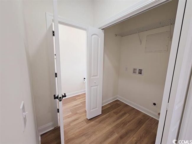 Clothes washing area with laundry area, wood finished floors, hookup for a washing machine, and baseboards | Image 32