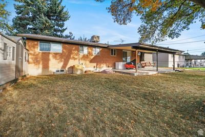 Rear view of house with a yard and a patio | Image 2