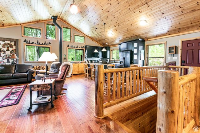 Living room featuring wooden ceiling, wood-type flooring, and high vaulted ceiling | Image 10