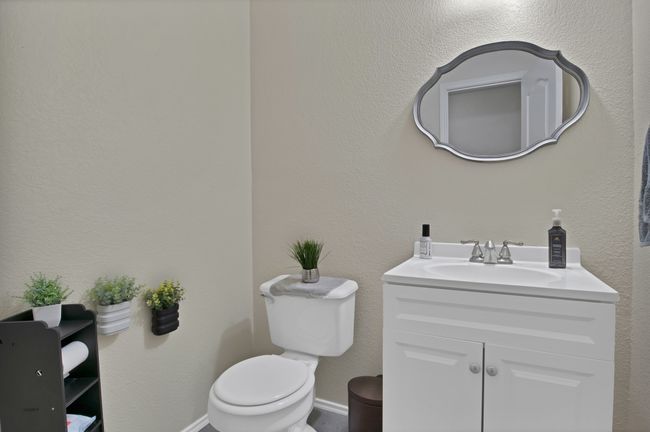 Half bathroom featuring toilet, vanity, and baseboards | Image 7