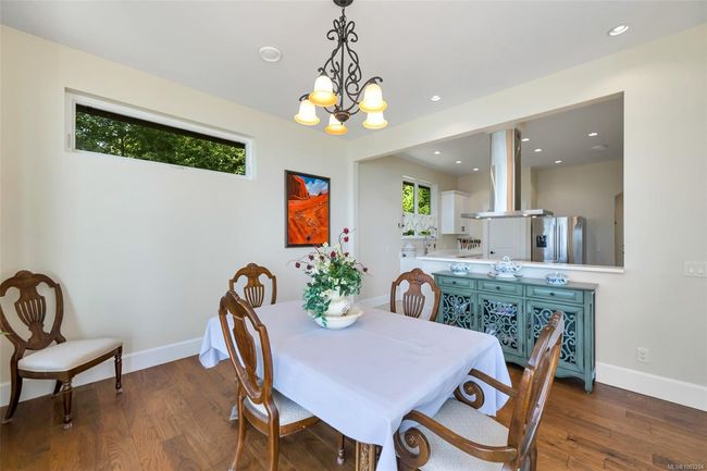 Dining space with wood finished floors, recessed lighting, and a chandelier | Image 70
