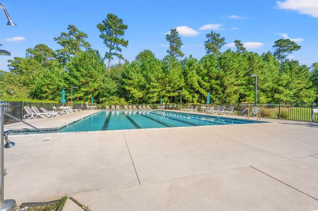 Community pool featuring fence and a patio area | Image 28