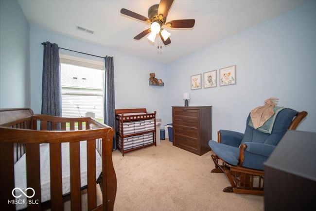 bedroom with light colored carpet and a ceiling fan | Image 21