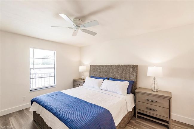 Bedroom with wood finished floors, baseboards, and ceiling fan | Image 16